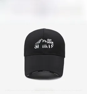 Close-up of white Outdoor Sports mountain embroidery on a black mesh baseball cap