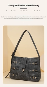 Detail of dark grey tote with triple buckle straps and metallic lobster clasp closure