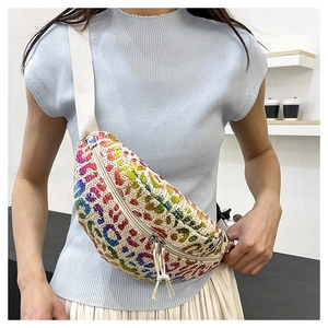 Close-up of a woven waist bag with colorful abstract patterns on a model's torso