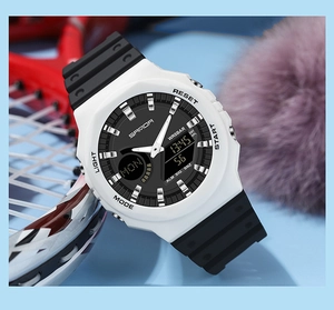 Dual-display sports watch with white case and black strap near badminton racket
