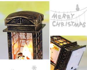 Detail view of vintage bronze Christmas lantern with snowman scene and top crown design