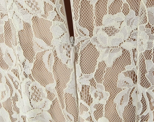 Detail of white lace dress showing beige lining and high-quality invisible back zipper