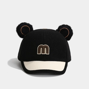 Detail of baby baseball cap with bear ears, wool fabric and letter m embroidery