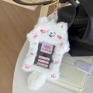 Plush cat card holder with pink ears and gold clasp hanging on a black leather bag
