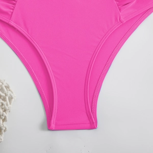 Detail of rose pink bikini bottom showing elastic knitted fabric and neat double-needle stitching