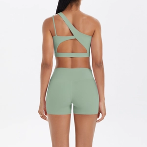 Back view of light green one-shoulder yoga bra and high-waisted shorts set