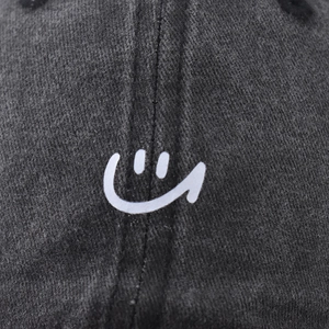 Charcoal grey washed cotton baseball cap with embroidered white smiley face logo