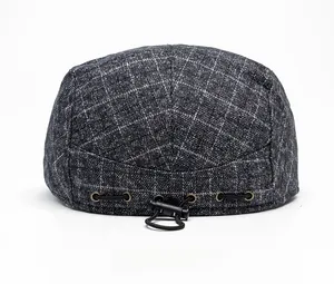 Detail of grey plaid beret back view featuring adjustable elastic drawstring toggle