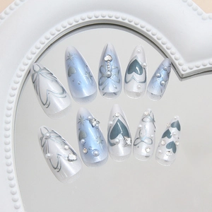 Dreamy blue and white gradient almond press-on nails with silver star and pearl charms