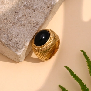 Detail of vintage 18K gold plated ring with black onyx inlay and textured vertical ridges