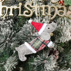 Detailed view of felt dachshund Christmas ornament wearing plaid sweater and Santa hat