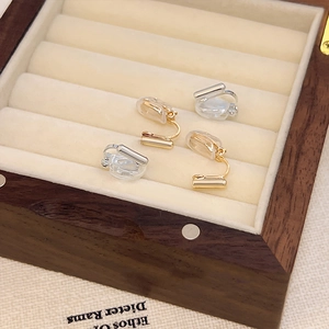 Minimalist gold and silver geometric screw clip-on earring converters on velvet padding