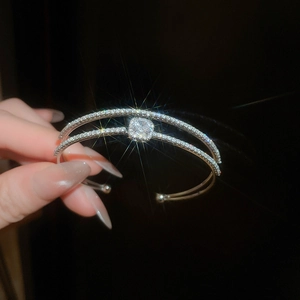 Detail of a silver double-layer open cuff bracelet with zircon and square stones