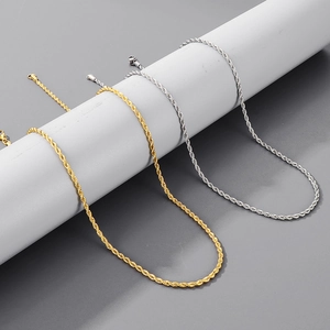 Close-up of 3mm gold and silver twisted rope necklaces on a gray display stand