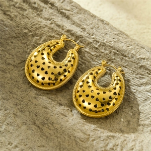 Golden U-shaped hollow earrings with star and heart patterns on stone background