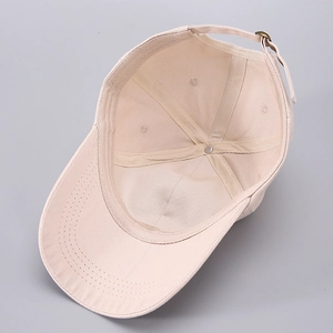 Detailed interior of the beige baseball cap showing sweatband and adjustable metal buckle