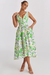 Close-up of white floral dress with green and yellow rose patterns and V-neckline detail