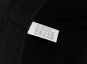 Macro shot of fedora hat interior showing the 35% cotton 65% polyester material label