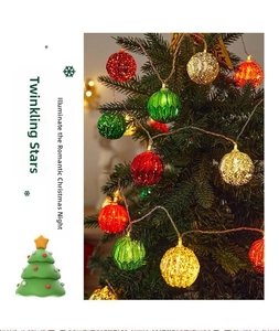 Close-up of red, green and gold LED Christmas ball string lights on a festive tree