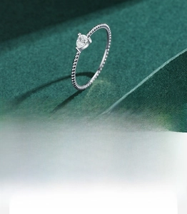 Macro detail of S925 sterling silver beaded ring with pear-shaped cubic zirconia stone