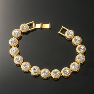 Iced out cuban link bracelet in gold finish with round cz stones on black background