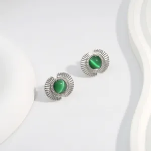 Close-up of fan-shaped silver studs with green cat eye stone and radiating texture