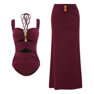 Detail of burgundy bohemian swimwear with wooden beads and hollow-out design elements