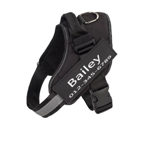 Adjustable K9 dog harness in black with reflective strips and custom ID name tag