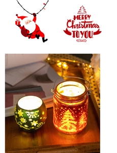 Close-up of glass Christmas candle holders with snowflake and pine tree patterns