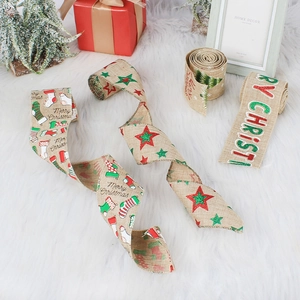 Christmas burlap ribbons with wire edges, stars, and Merry Christmas prints on plush white