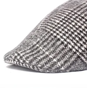 Close-up of classic wool blend plaid newsboy cap showing detailed brim stitching and texture