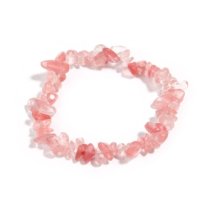 Macro shot of irregular pink strawberry quartz crystal fragments on elastic beaded bracelet