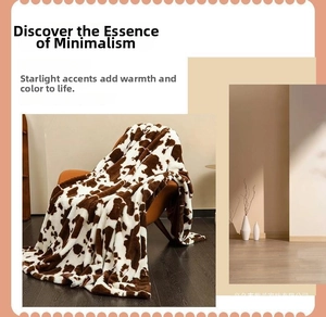 Detailed texture of cow print flannel blanket on sofa with soft plush material