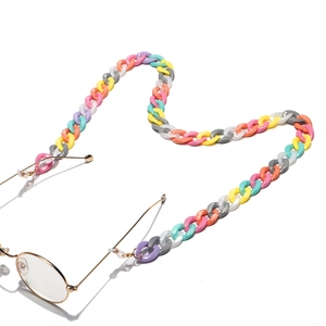 Colorful acrylic chain for glasses shaped in a heart style on white background
