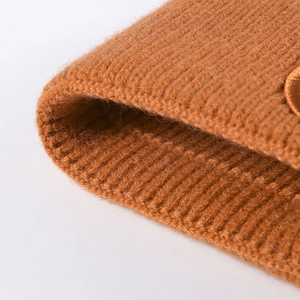 Close-up of caramel ribbed knit beanie featuring premium thick texture and soft wool blend