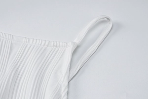 Close-up of white ribbed knit fabric texture and strap stitching on a slim dress