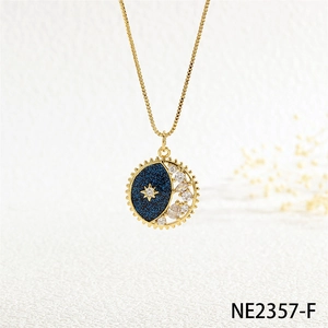 Detailed close-up of celestial moon and star pendant with blue glitter and gold accents