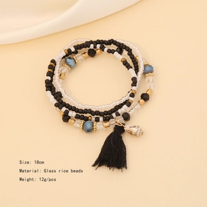 Detail of beaded bracelets with black tassels and shell pendant, 18cm glass bead jewelry