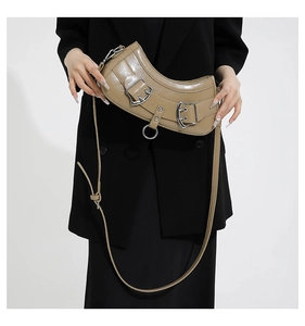 Close-up of khaki PU leather half-moon bag with silver metal buckles and rings