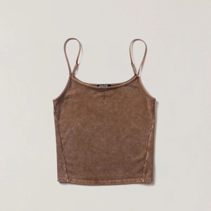 Detail of cross embroidery and logo label on a brown vintage wash cotton camisole top