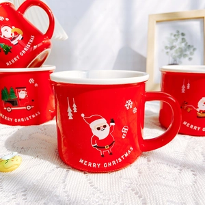 Red ceramic Christmas mug with Santa Claus pattern and Merry Christmas text