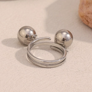 Adjustable silver stainless steel ring featuring unique double hanging ball charms