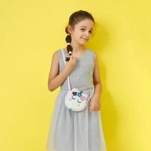 Toddler girl wearing unicorn plush crossbody bag with colorful sequins and pink strap