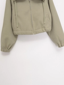 Detail of light olive drawstring hoodie featuring a durable zipper and ribbed cuffs