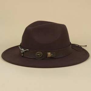Detail of western fedora hat with brown leather band and silver bull head metal ornament
