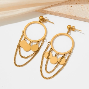 Elegant gold drop earrings with tiered chains and circular charms on a stone background