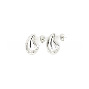 Macro detail of polished teardrop earrings featuring high-shine mirror finish and secure butterfly back