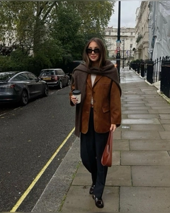 Close-up of caramel suede blazer with vintage lapel and single-breasted button details