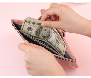 Close-up of pink short wallet showing interior card slots and cash compartment