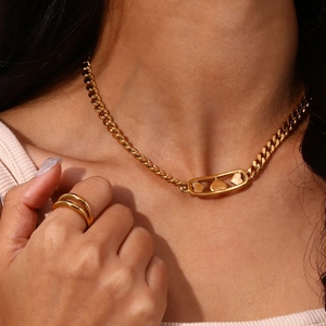 Detail of 18K gold plated double-layer round line ring and heart pin necklace on model